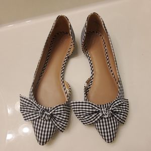 Black and White checkered slip on shoes.